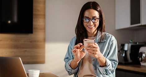 Kvinna med mobil är glad